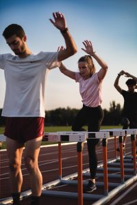 1000026047 A kid running over small hurdles.